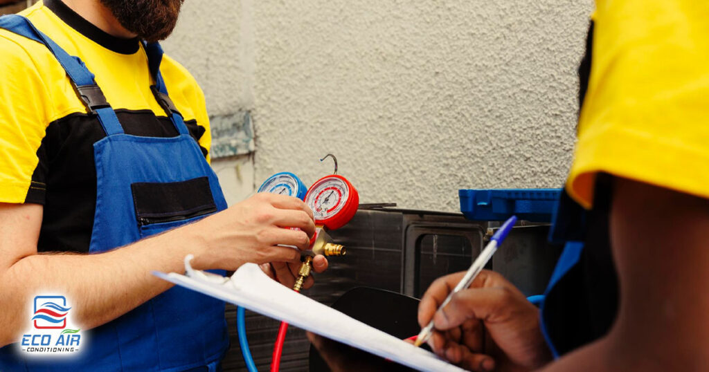 air conditioning repair workers refilling freon